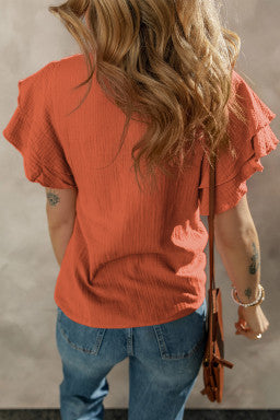 Stand out with the vibrant orange hue of this ruffle sleeve blouse, adding color while keeping a casual-chic vibe.
The solid design offers easy styling for both dressy and casual looks.
Delicate ruffle detail adds a feminine touch and day-to-night versati